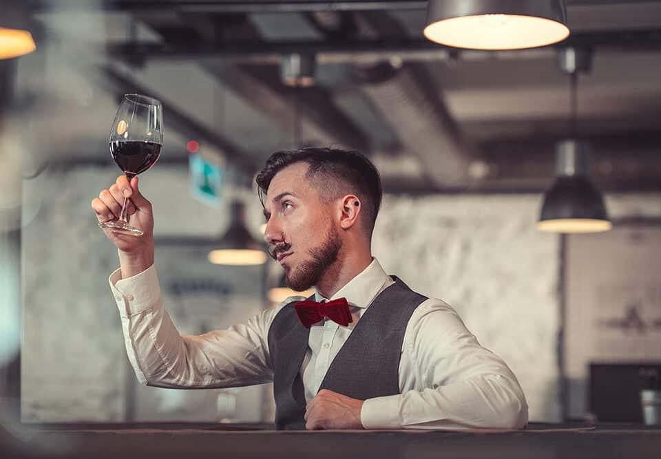 Young sommelier with a glass of wine